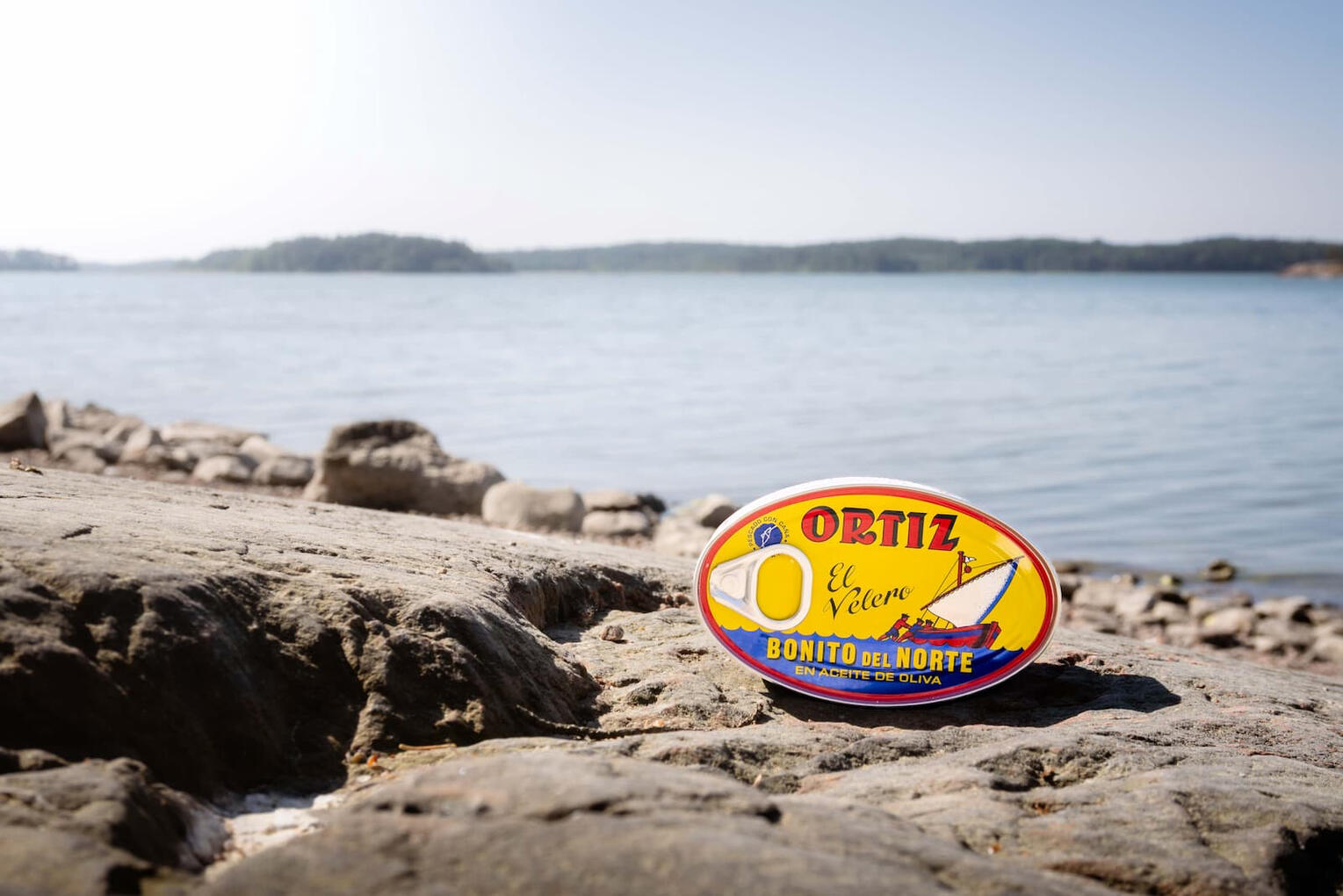 Kuva Ortiz-tonnikalapurkista kalliolla, taustalla Itämeri ja saaristomaisema.